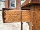 Antique Oak Desk With Tilting Top On Wooden Casters