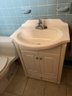 A Wood Vanity With 1 Piece Corian Type Sink - Powder Room