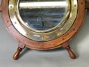 A Vintage Wooden Ships Wheel & Brass Porthole Mirror