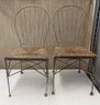 Two Metal Chairs With Woven Seats
