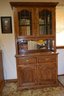 Lighted Two Piece Wood, Glass And Mirror-backed Hutch With Dental Trim, Two Drawers And 4 Shelves Total