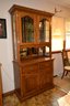 Lighted Two Piece Wood, Glass And Mirror-backed Hutch With Dental Trim, Two Drawers And 4 Shelves Total