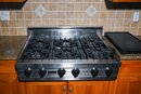 A Viking 36 Inch Pro-Style Gas Range Top With 6 Open Burners With Vari-Simmer