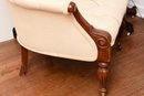 Upholstered Tufted Carved Mahogany Club Chair With Front Casters