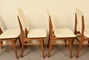Set Of Four Mid-Century Teak And Faux Leather Chairs
