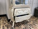 French Style Distressed Bombe Display Cabinet With Adjustable Glass Shelves And Two Drawers
