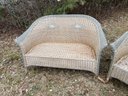 A Wicker Sofa And Two Loveseats
