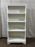 A Small, Four-Shelf Painted Bookcase With A Tapered Profile