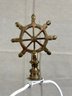 A White Metal Floor Lamp With A Brass Ship's Wheel Finial