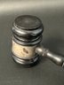 A Vintage Wooden Gavel With Engraved Metal Band