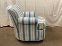 A Vintage Upholstered Arm Chair With A Swivel Base