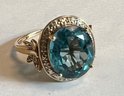 STUNNING 10K GOLD BLUE TOPAZ SURROUNDED BY DIAMONDS RING