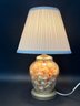 A Vintage Glass Urn Lamp Filled With Natural Seashells