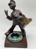 Vintage 1929, Gift House NYC Mailman Statue Patinated Metal Ashtray With Cigarettes And Match Holder.