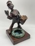 Vintage 1929, Gift House NYC Mailman Statue Patinated Metal Ashtray With Cigarettes And Match Holder.