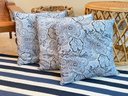 A Trio Of Blue And White Decorative Pillows