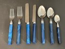 A Beautiful Set Of Stainless Flatware With Blue Marbled Handles