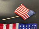 A Silk American Flag & A Small American Flag On A Stick