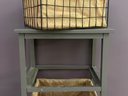 A Three-Tier Wooden Vegetable Bin With Burlap-Lined Wire Baskets
