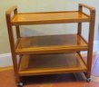 A Wooden Rolling Cart With 2 Shelves