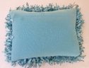 A Truly Wild Teal Colored Designer Pillow Covered In A Chenille Fringe