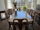 A Vintage Banded Mahogany Pedestal Base Dining Table And Chairs With Pads, Extra Extension, Possibly Baker