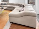 A NATUZZI  White Leather  Three Pieces Sectional Couch With Adjustable Head Rest