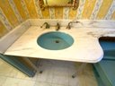 A Marble Top Vanity With Glass Legs