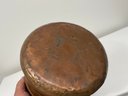 An Antique Copper Pot With Brass Handles