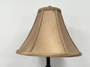 A Bronze Tone Stick Lamp With Silk Shade