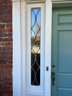 A Leaded Glass Front Entry And Door With Brass Hardware