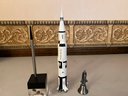Lot Of Space Items Including Pen Set With Satellite, 1997 Dated Rocket, And Bell