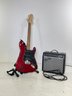 A Squier Stratocaster Electric Guitar And Amp By Fender