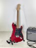 A Squier Stratocaster Electric Guitar And Amp By Fender
