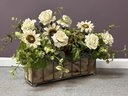 An Elegant Faux Floral Arrangement In A Burlap-Lined Wire Basket