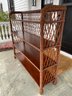 A Vintage Bookshelf With Woven Reed Back