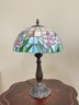 A Bronze Accent Lamp With Stained Glass Shade