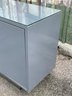A Modern Grey Lacquer And Glass Top Credenza