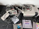 AN NES WITH CONTROLLERS AND LOOSE GAMES