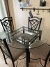 Contemporary Glass Top Round Table And Four Chairs .