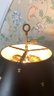 A Vintage Brass And Glass Bouillotte Lamp With Fleur De Lis Tin Shade