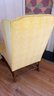 An Antique Yellow Upholstered Wing Chair