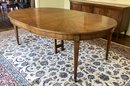 A  Vintage Baker Furniture Oval Dining Table With One Leaf.