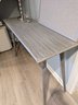 Contemporary Grey Console That Includes A Lamp, Pen Holder And Peg Board
