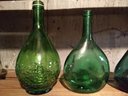 Four Vintage Decorative Green Bottles Various Sizes And Shapes
