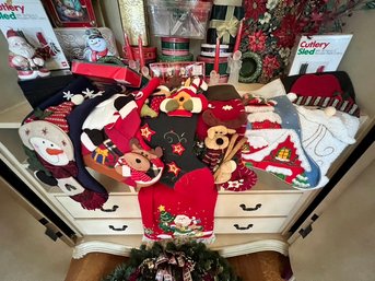 Christmas Lot Of Stockings, Cans, Boxes, Tree Skirt, Candles, And More