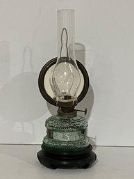 Reflective Oil Lamp On A Small Pedestal