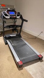 A Sole Fitness F85 Folding Treadmill On Wheels