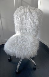 A Faux Fur Armless Swivel Desk Chair On Wheels