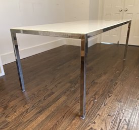 An Ikea Glass Top High Gloss White Table With Chrome Plated Legs